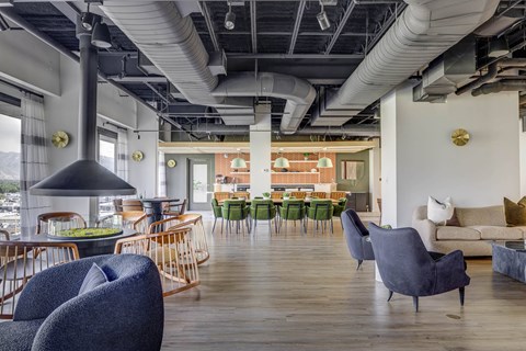 a living room with couches chairs and a table in a lobby